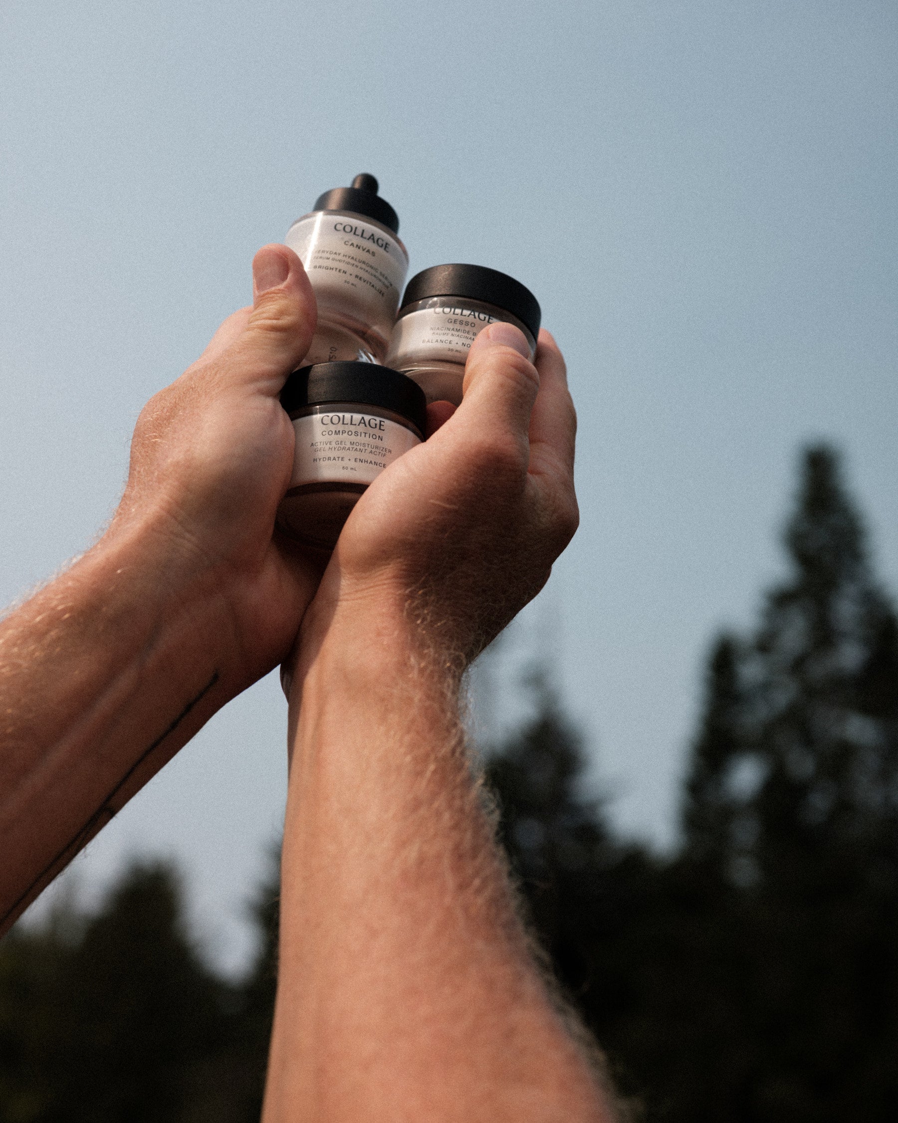 Hand holding three small jars with visible Collage branding against a blurred natural background