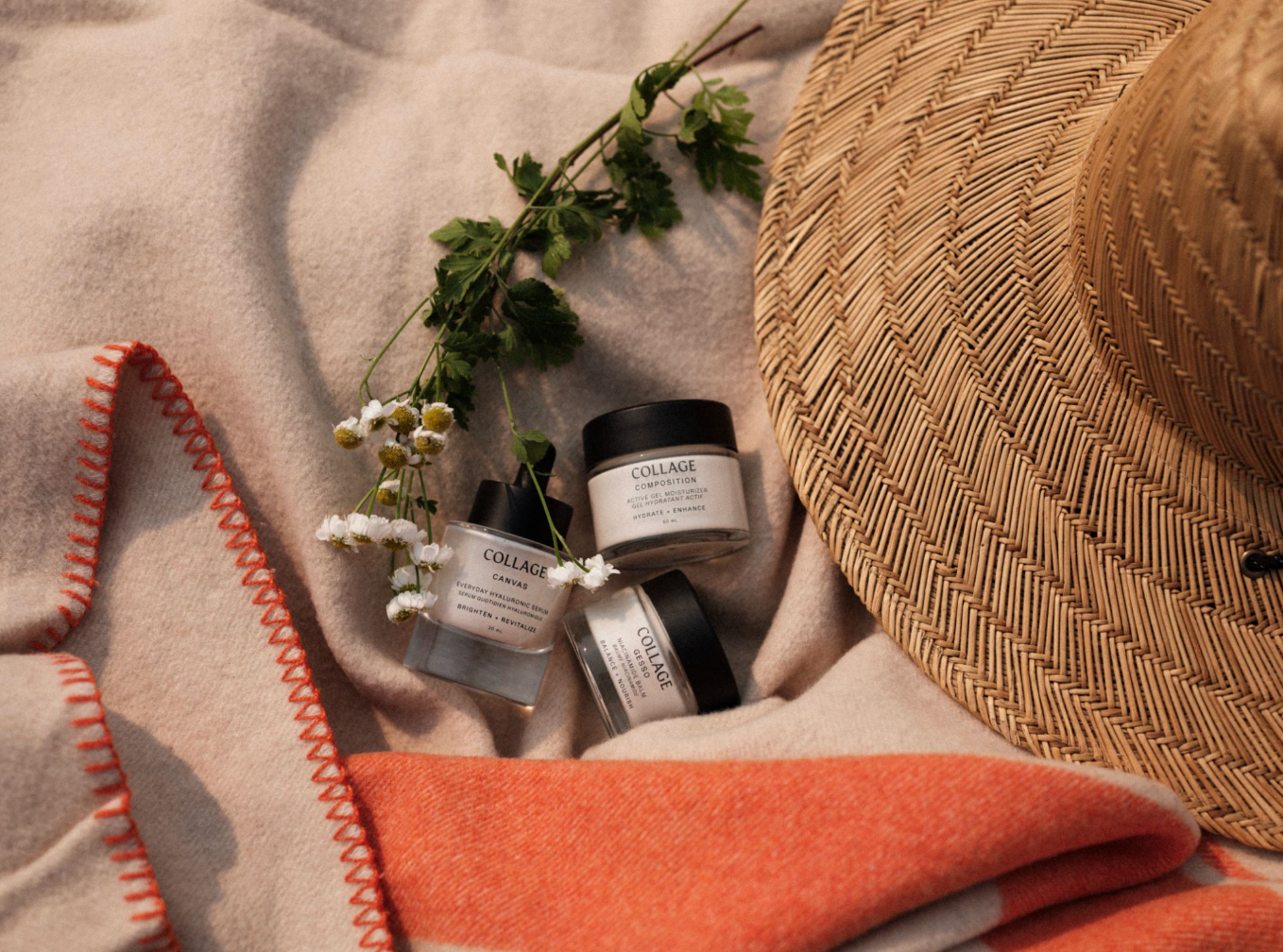 Collage skincare jars on a blanket with a straw hat and flowers